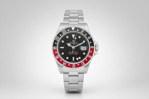 Rolex watch with black face, red bezel, and silver metal strap on a white background