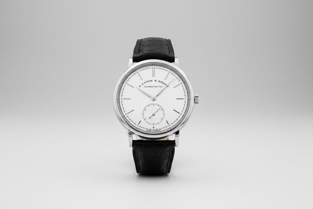 Watch with black leather strap and silver case on a white background